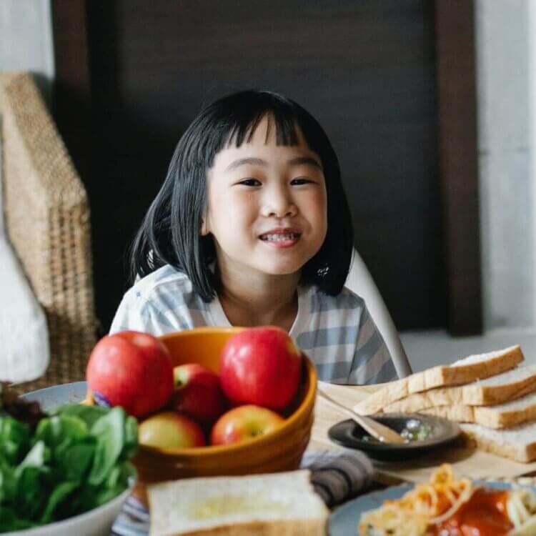 Little girl at the dinner table