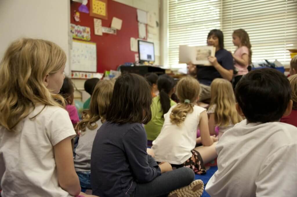 Students watching teacher read