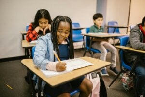 Elementary students writing at their desks