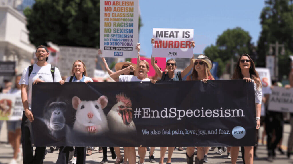 Humans marching with an End Speciesism banner