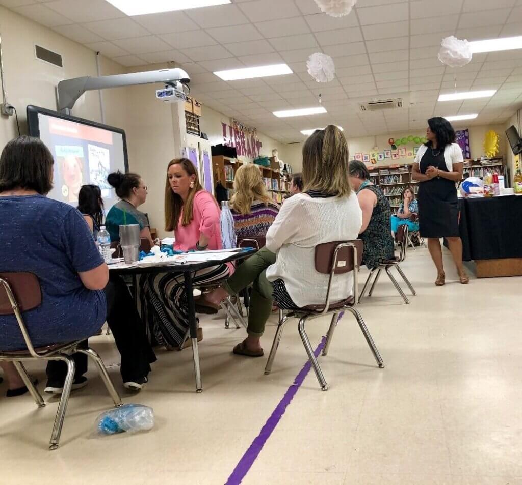 TeachKind staffer presents to a group of educators in a classroom