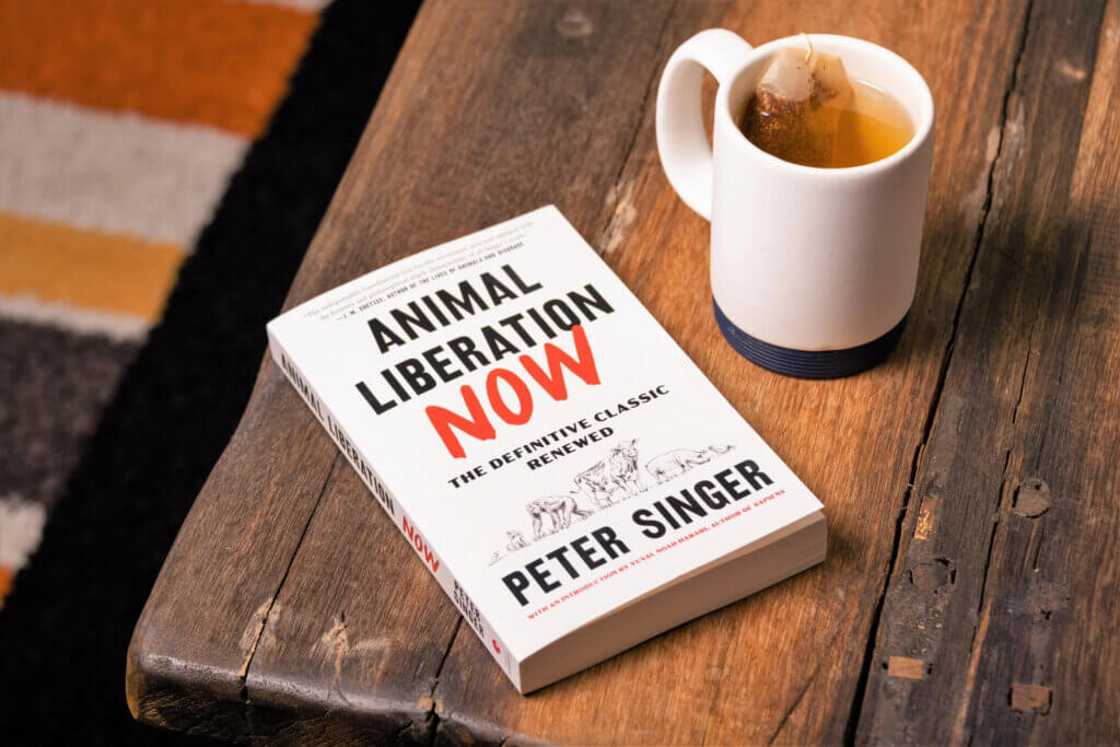Animal Liberation Now on a table with tea