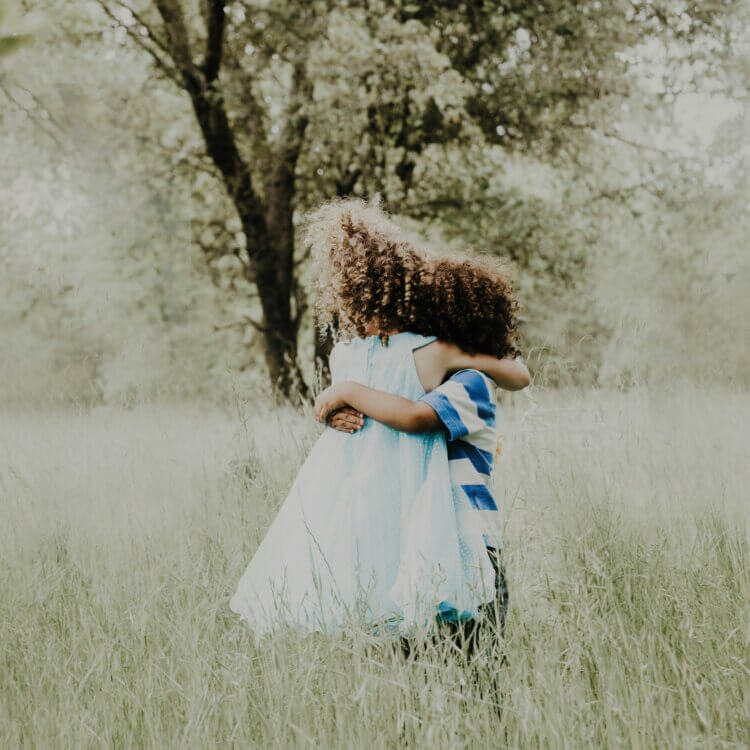 two kids hug