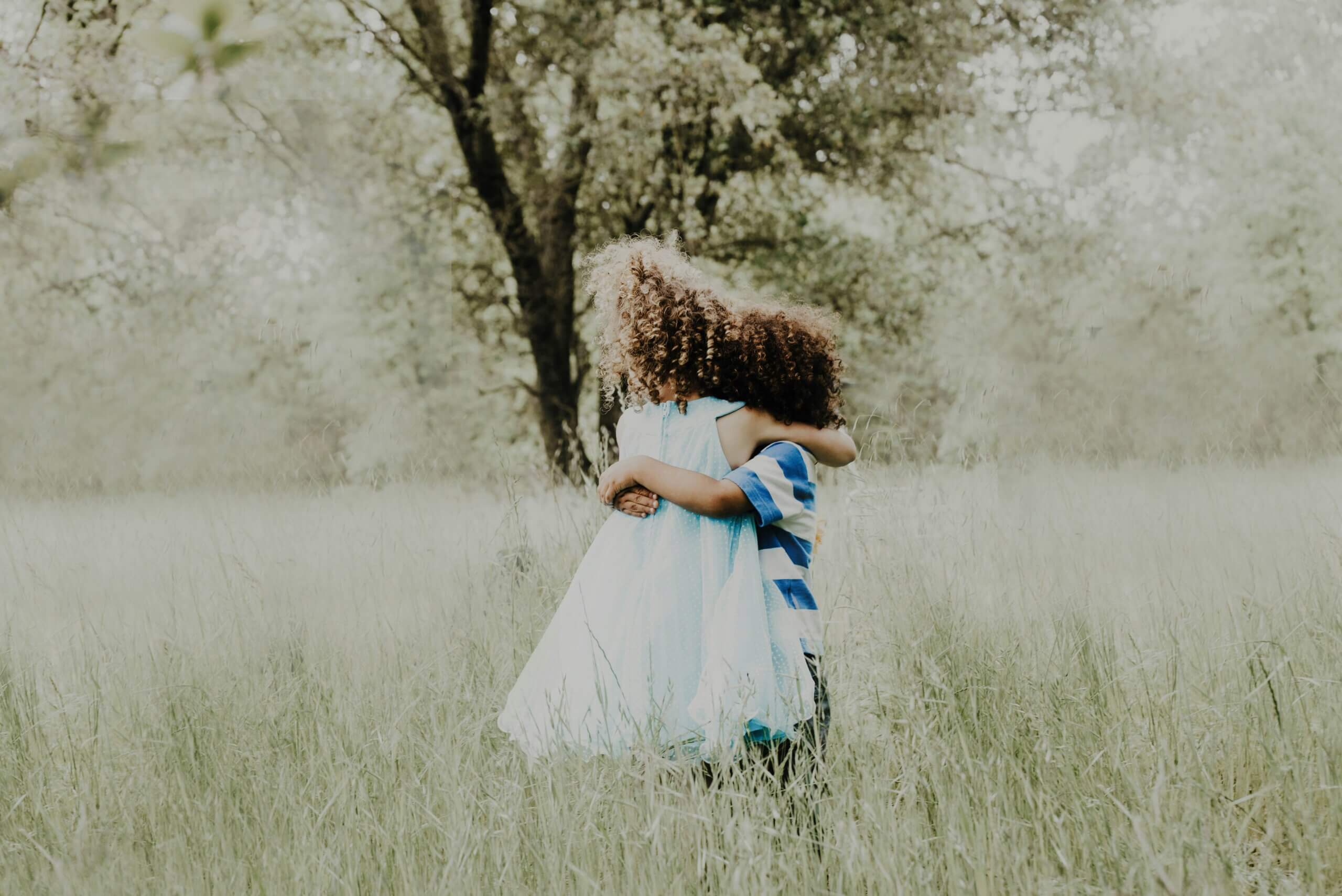 two kids hug