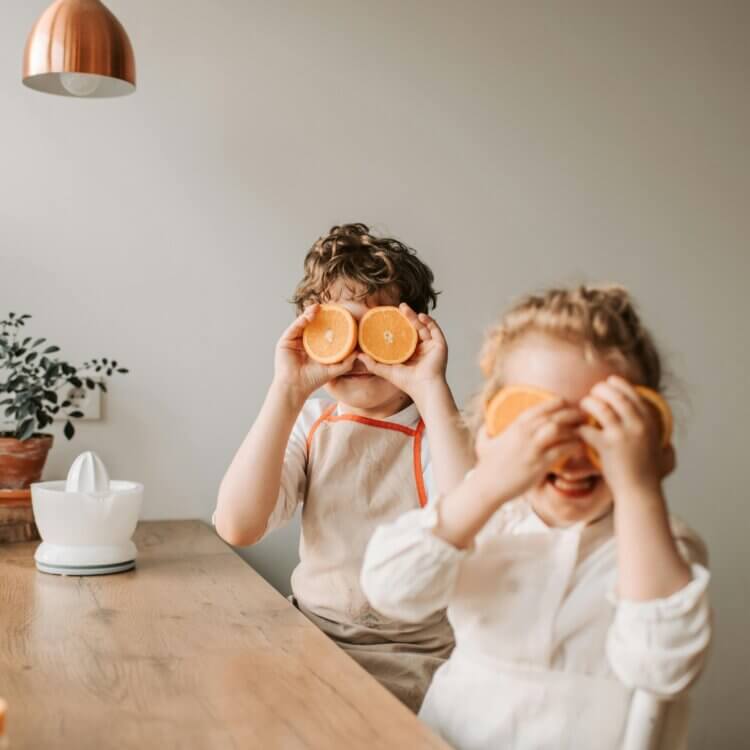 kids playing with orange slices