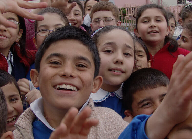 Kids smiling and waving