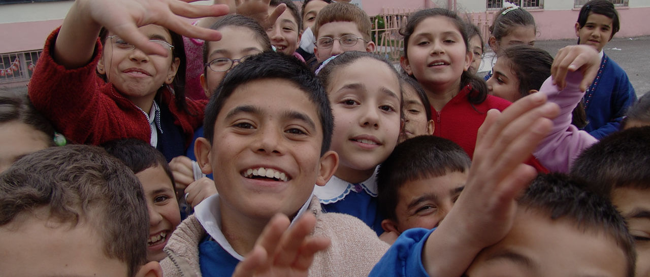Kids smiling and waving