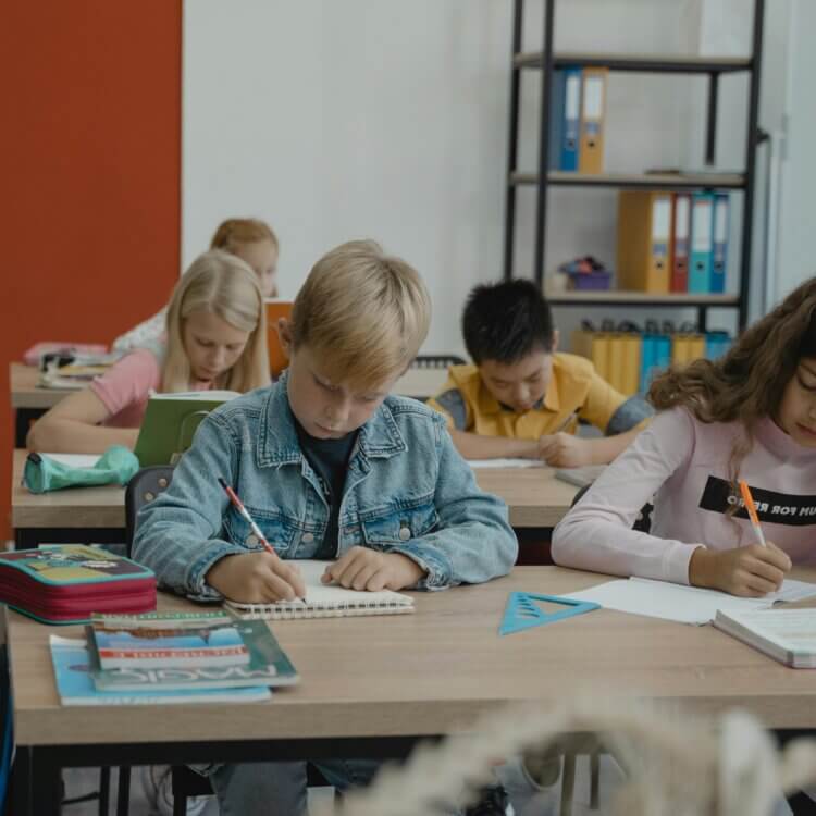 students writing at their desk