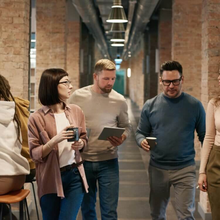 Photo Of People Walking Down Hallway