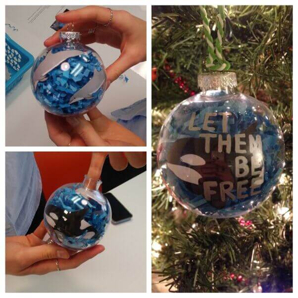 Ornament with pictures of orcas and dolphins with "Let Them Be Free" written on it.