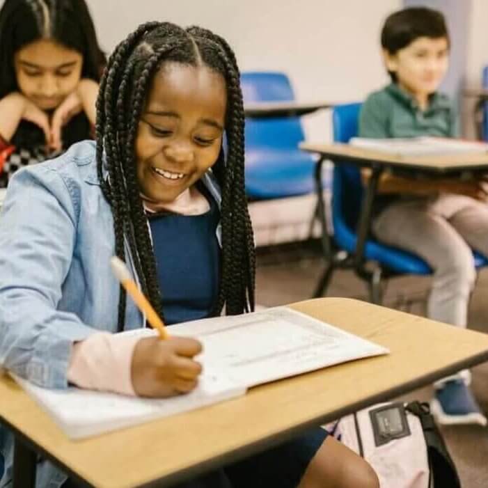 Elementary students writing at their desks
